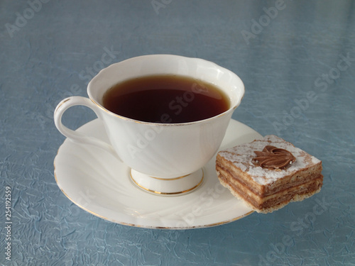 Porcelain tea cup and cake