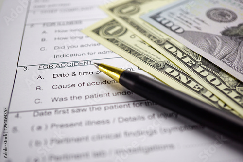 Health insurance accident claim form with coin money and car. 