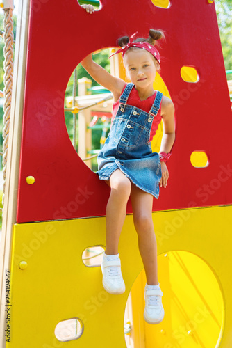 little girl is playing on the playground