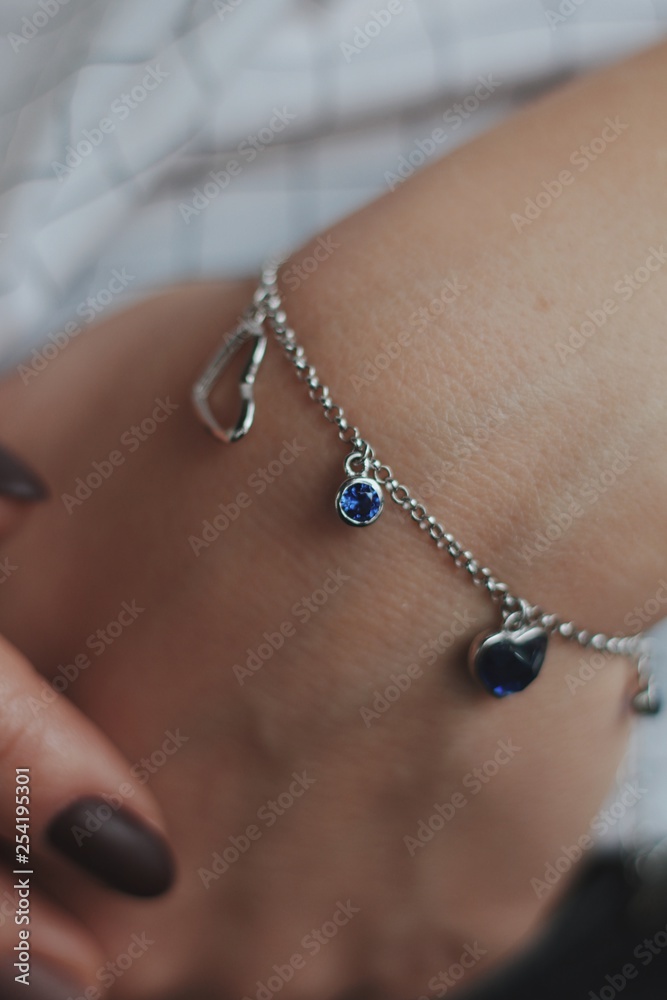 multicolored precious bracelet on the girl's hand close up multicolored precious bracelet on the girl's hand close up