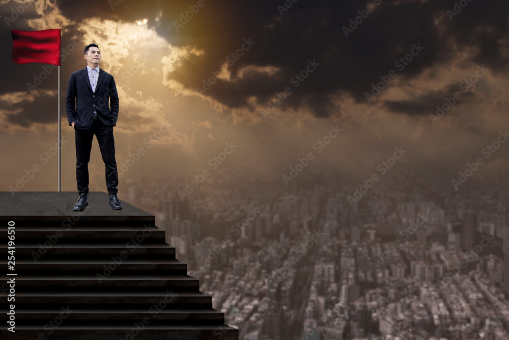 Success and effort man concept, business people  in suit standing with winner flag and looking over cityscape view and thinking business plan of the future