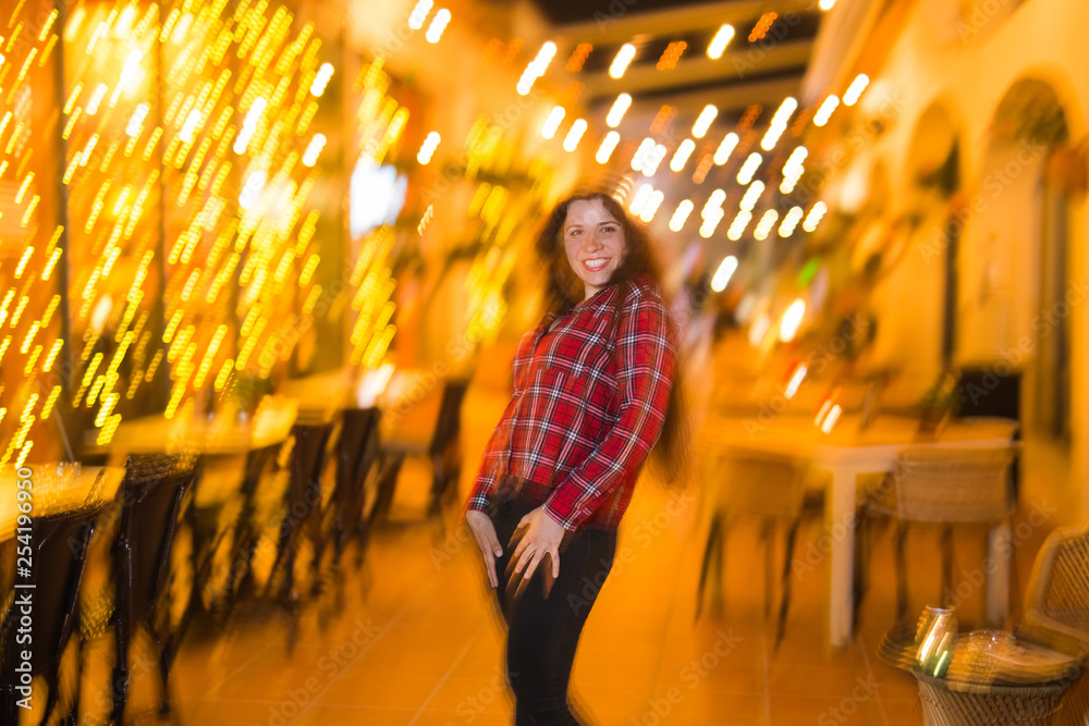 Nightlife, party and lifestyle concept - Girl walking in night city, soft focus and blurred Nightlife, party and lifestyle concept - Girl walking in night city, soft focus and blurred