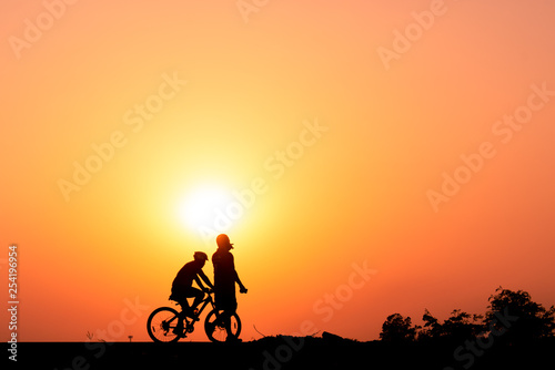 ride a bicycle ,silhouette background.