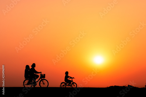 ride a bicycle ,silhouette background.