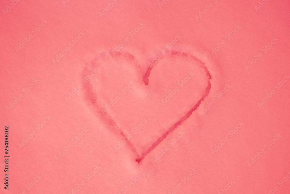 Pink heart painted on pink snow, close-up