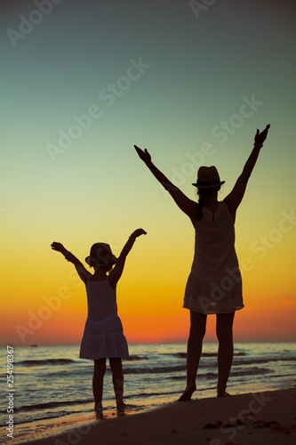 young mother and daughter travellers rejoicing