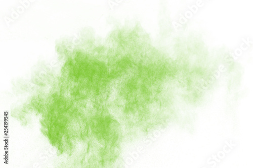 Green powder explosion on white background. Colored cloud. Colorful dust explode. Paint Holi. © kitsana