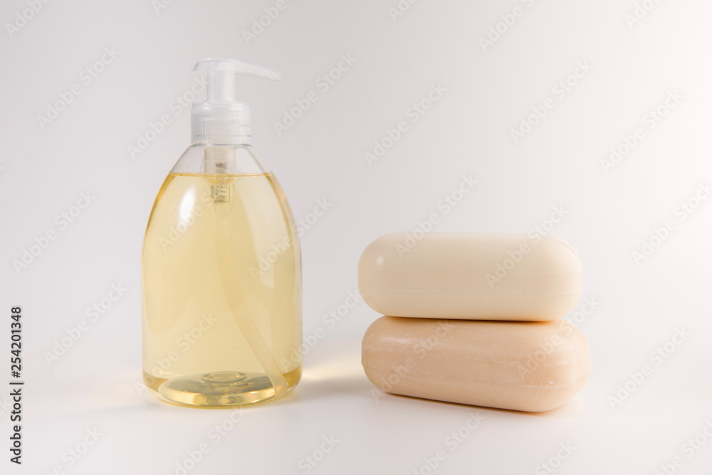 liquid soap and two pieces of solid soap isolated on white background liquid soap and two pieces of solid soap isolated on white background
