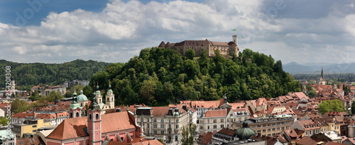 Panorama of Old Town of Lubljana Slovenia from the Skyscraper of churches of St Joseph, St Nicholas, Franciscan and St James with hilltop Castle