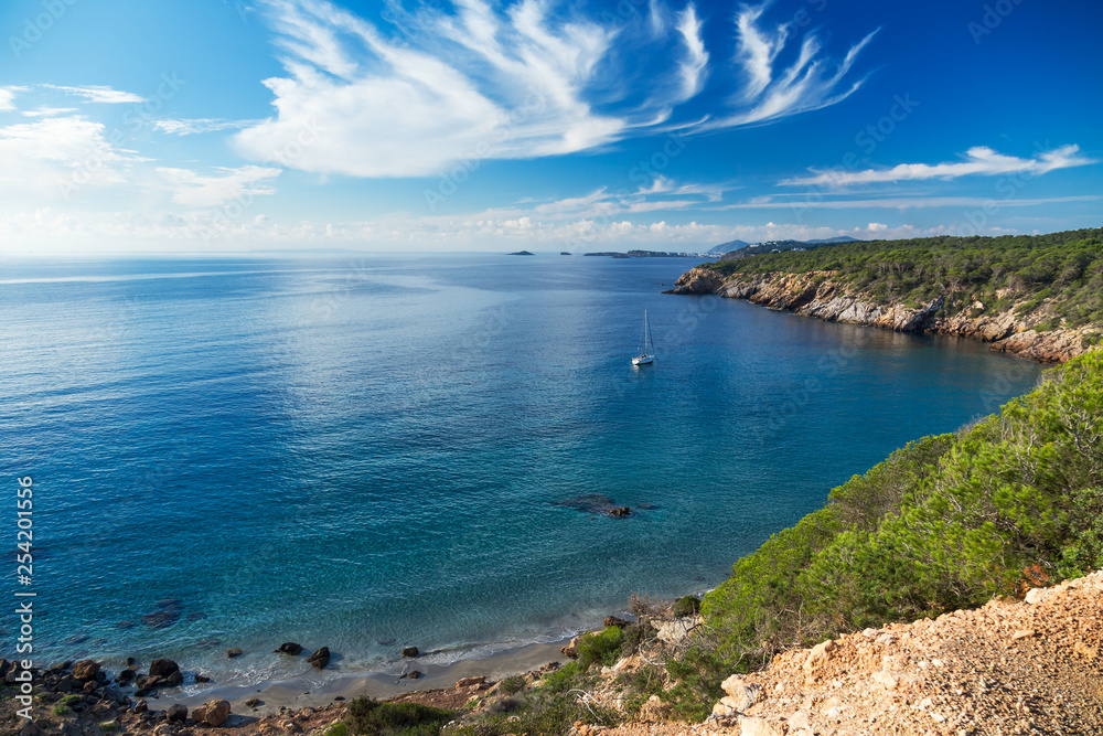A quiet bay with a sailing boat on Ibiza island, Spain