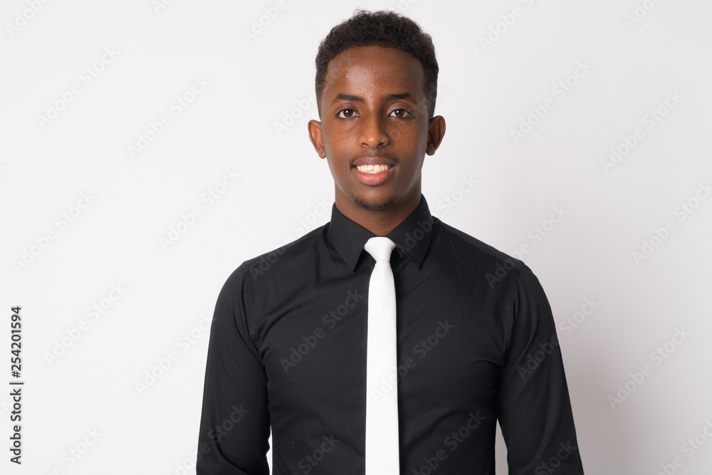 Portrait of happy young African businessman with Afro hair smiling Portrait of happy young African businessman with Afro hair smiling
