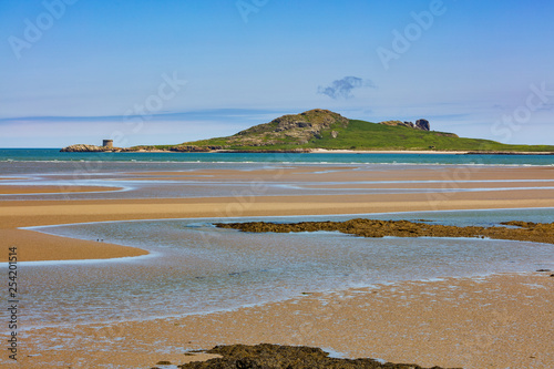 Ireland's Eye is an island on the East coast of Ireland near Howth as seen from Burrow Beach of Sutton, Dublin photo