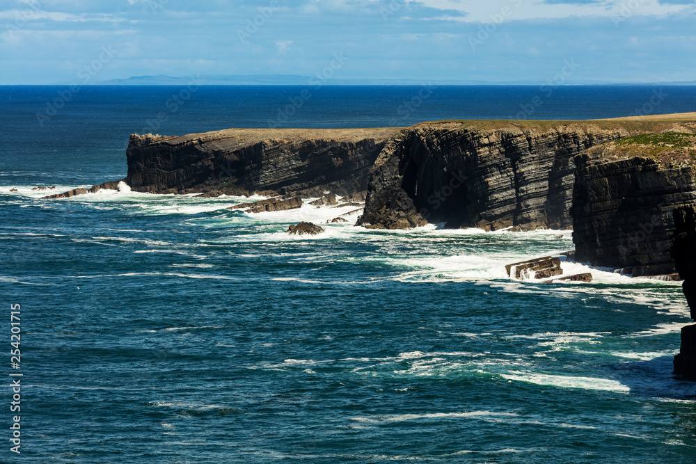 Cliffs of Loop Head, Kilbaha, Co. Clare, Ireland. Unique geological rock formations has formed over millions of years due to water erosion by the crashing waves of the North Atlantic Ocean. Cliffs of Loop Head, Kilbaha, Co. Clare, Ireland. Unique geological rock formations has formed over millions of years due to water erosion by the crashing waves of the North Atlantic Ocean.