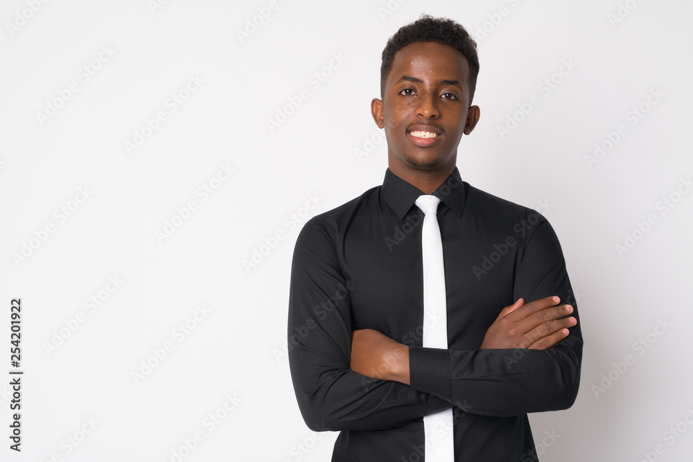 Portrait of happy young African businessman smiling with arms crossed Portrait of happy young African businessman smiling with arms crossed