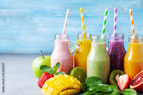 Summer colorful fruit smoothies in jars with ingredients. Healthy, detox and diet food concept.