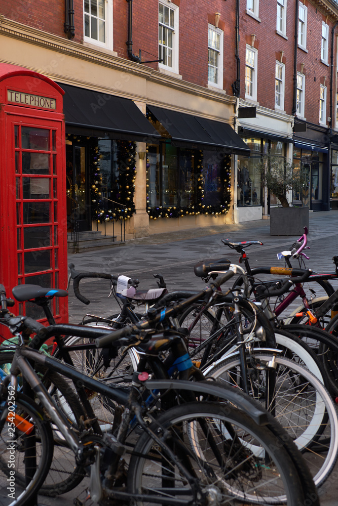Bicycle parking on the street of London next to the phone booth