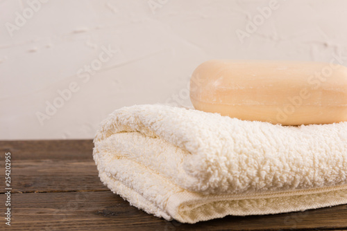 a piece of soap with towel on wooden table