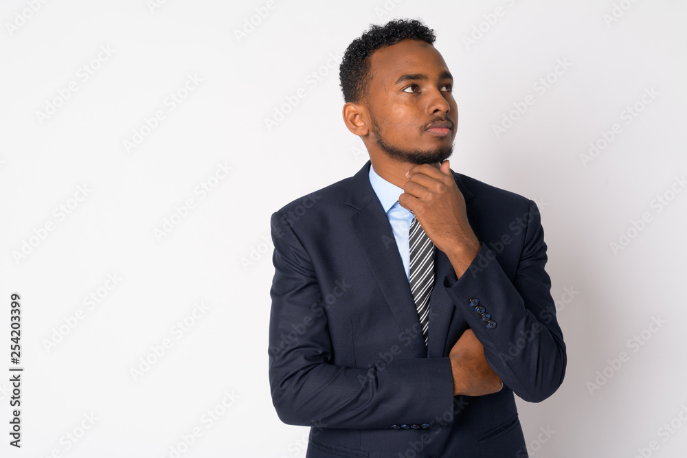 Portrait of young handsome African businessman in suit thinking Portrait of young handsome African businessman in suit thinking