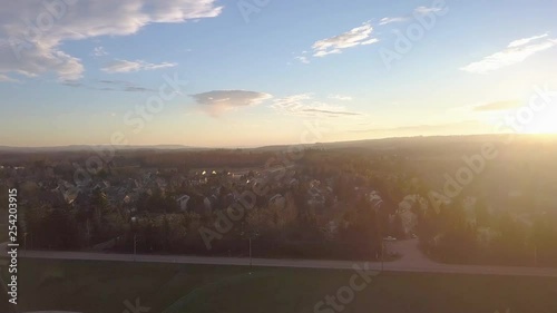 Rising drone shot above a baseball field and subdivision at sunset. photo