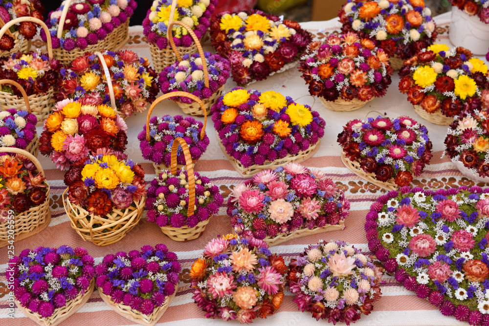 Hand crafted dried pink purple and yellow flowers at an open air stall at the Ljubljana Central Market Vodnik Square Ljubljana Slovenia