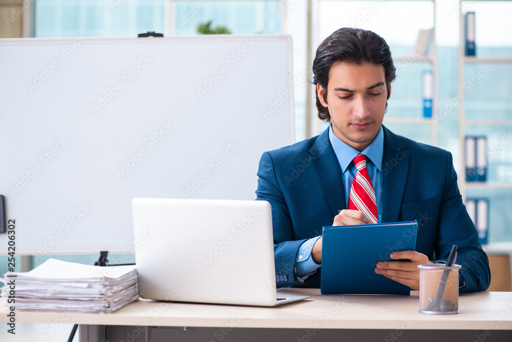 Young handsome businessman in front of whiteboard Young handsome businessman in front of whiteboard