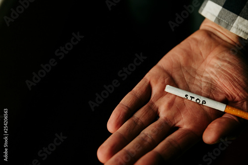 Cigarette in hand. Stop smoking. Concept stop nicotine
