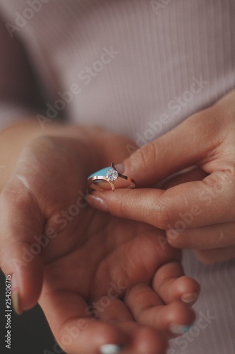 precious ring with a stone in the hand of a girl