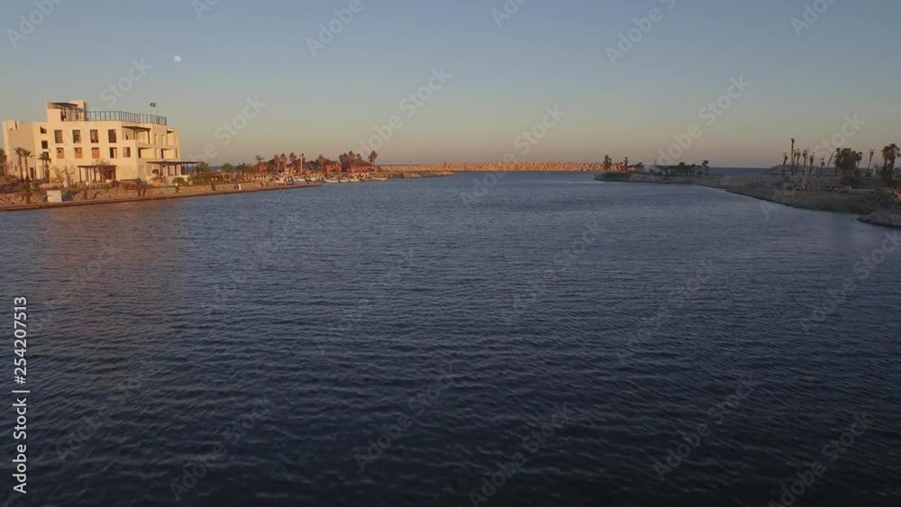 Aerial shot of a flying bird the Marina of San Jose del Cabo at sunset, Baja California Sur