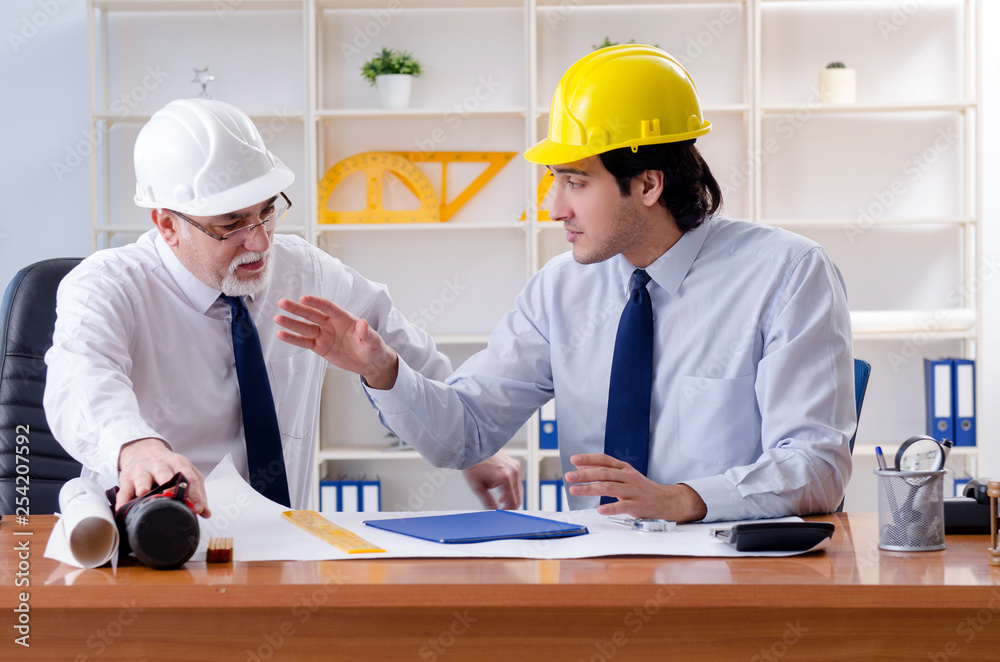 Two engineers colleagues working under project Two engineers colleagues working under project