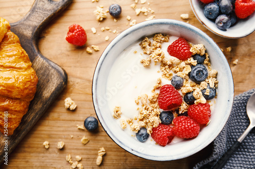 Yogurt with berries and granola in bowl