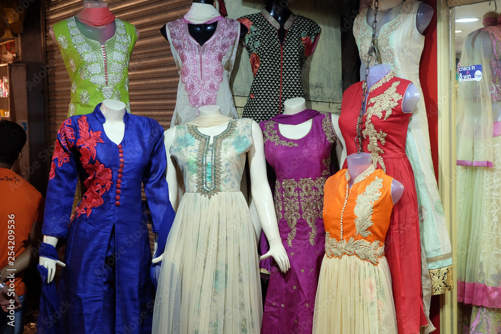 Mannequins dressed in latest Indian dresses in front of a retail cloth shop in Kolkata, India 