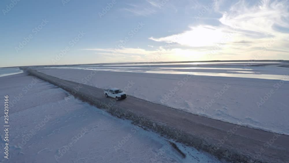 Aerial rolling shot shot of a pickup in the salt flats by solar evaporation in Guerrero Negro, Ojo de Liebre lagoon, Biosphere Reserve of El Vizcaino, Baja California Sur. Aerial rolling shot shot of a pickup in the salt flats by solar evaporation in Guerrero Negro, Ojo de Liebre lagoon, Biosphere Reserve of El Vizcaino, Baja California Sur.
