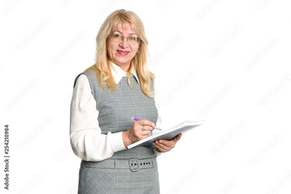 Mature woman makes notes in a notebook. Senior woman writing signatures and documents. Teacher. Mature woman makes notes in a notebook. Senior woman writing signatures and documents. Teacher.