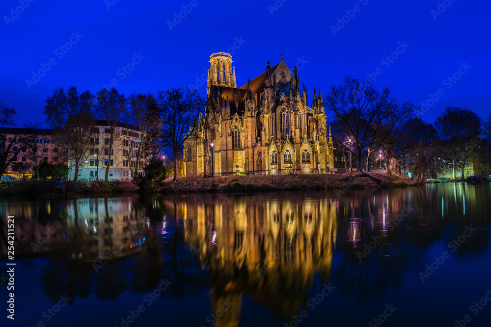 Germany, Stuttgart feuersee cathedral and houses reflecting in lake