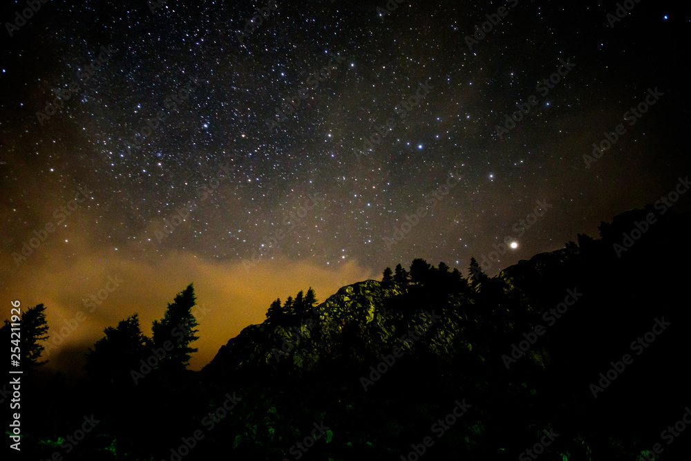 Starry nigjt on the mountains with the Milky Way and pine trees Starry nigjt on the mountains with the Milky Way and pine trees
