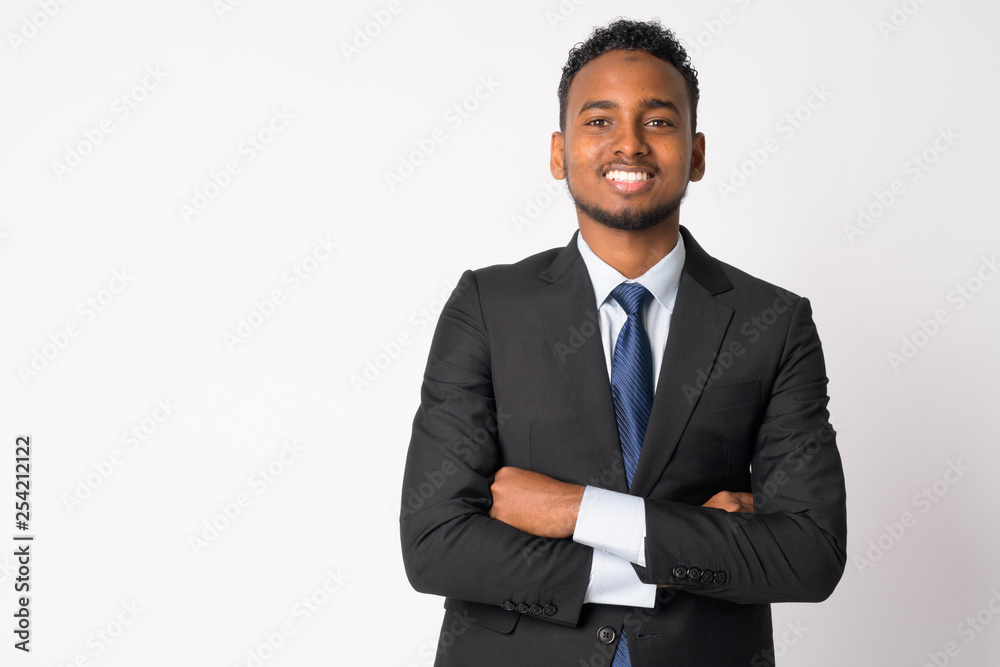 Happy young handsome African businessman smiling with arms crossed Happy young handsome African businessman smiling with arms crossed