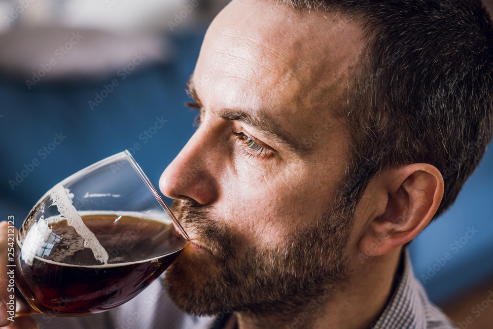 Man tasting freshly brewed beer. Selective focus. Man tasting freshly brewed beer. Selective focus.