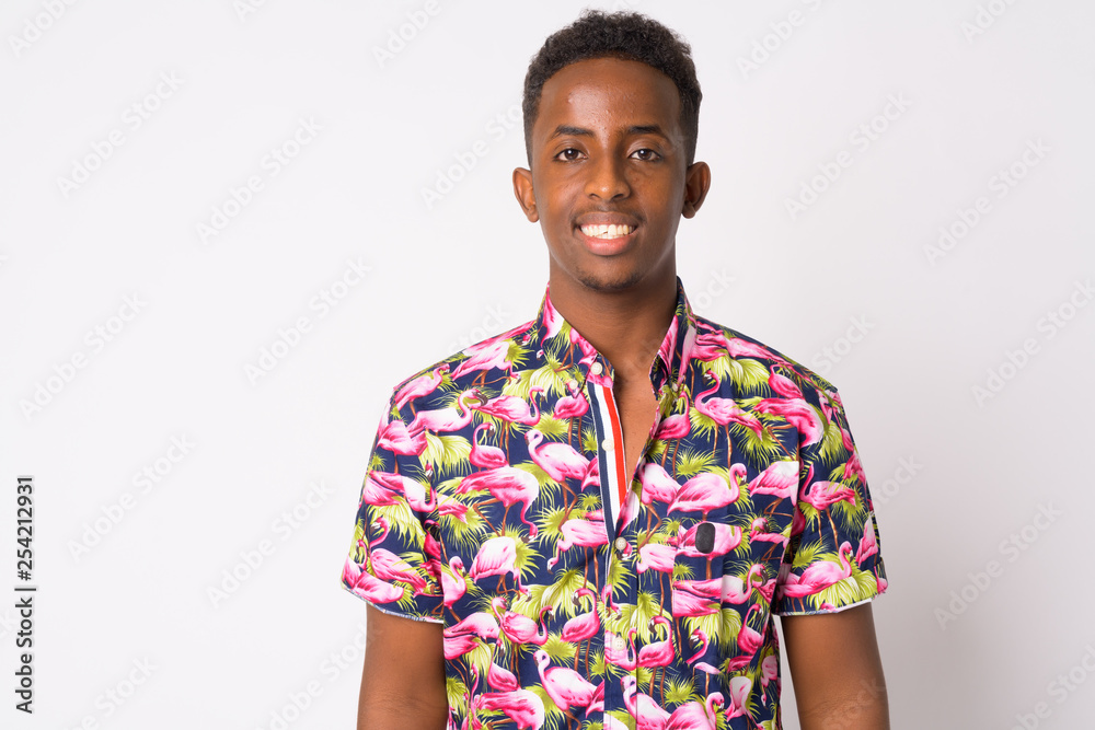 Portrait of happy young African tourist man with Afro hair smiling Portrait of happy young African tourist man with Afro hair smiling