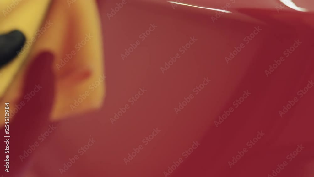 Slow motion closeup of wiping red car with microfiber cloth Slow motion closeup of wiping red car with microfiber cloth