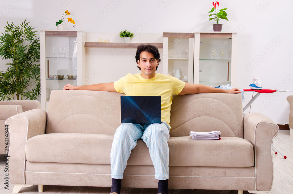 Young man husband ironing at home Young man husband ironing at home
