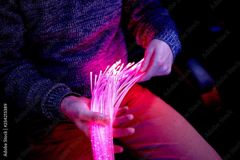man in color therapy in the retirement care home. multi sensory stimulating room