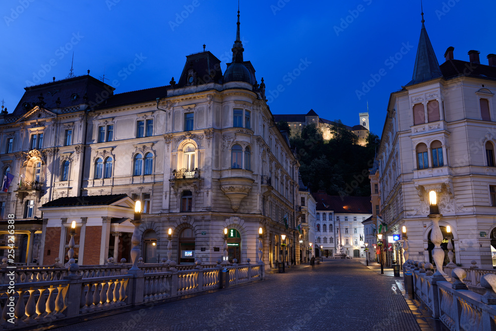 Stritar Street at dawn between Kresija Building and Philip Mansion towards Ljubljana Castle Hill from Triple Bridge in Old Town Ljubljana Slovenia