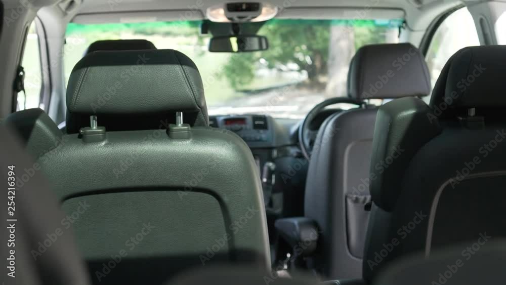 SLOWMO - Interior of luxury minivan black leather seats and cockpit from back to front SLOWMO - Interior of luxury minivan black leather seats and cockpit from back to front