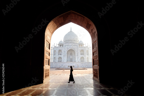 Young woman walking with view of the Taj Mahal, Agra, India