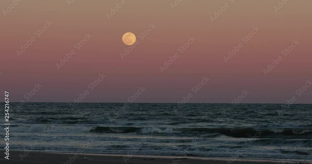 Full moon over night surf Gulf of Mexico Texas. Beautiful southern
