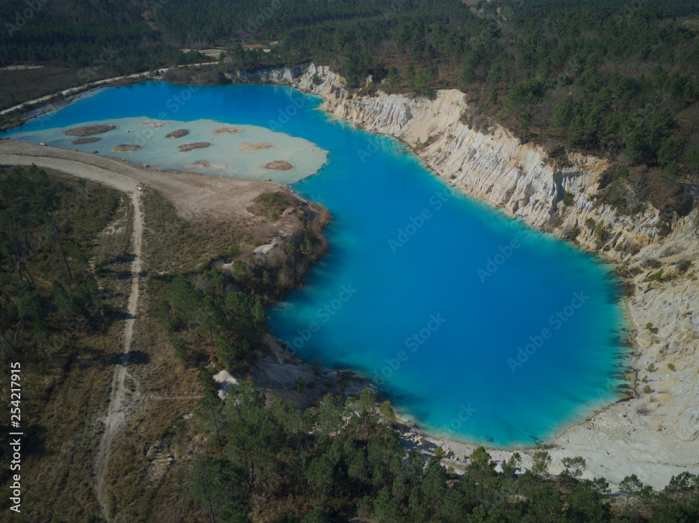 Old clay quarry turned into a lake, drone point fo view