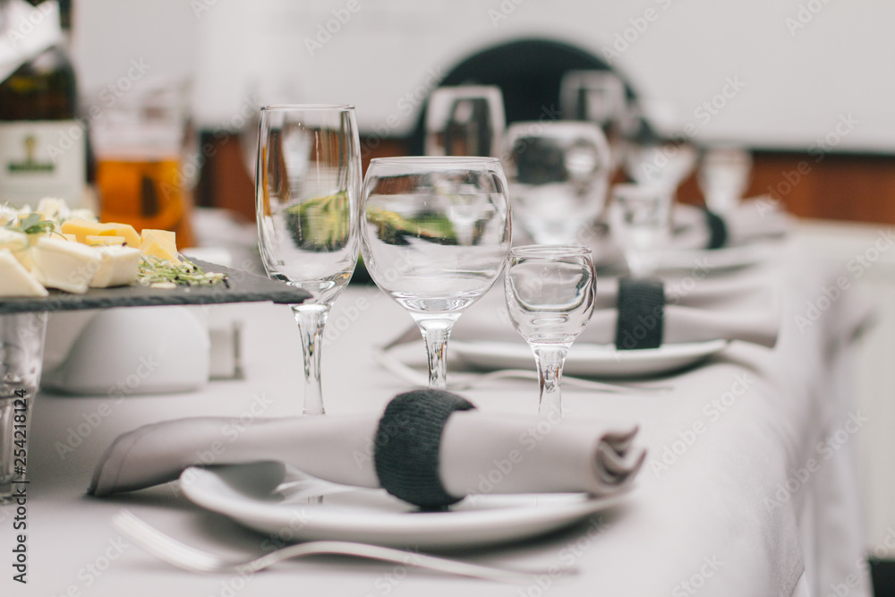 Fototapeta premium Empty glasses set in restaurant. Part of interior