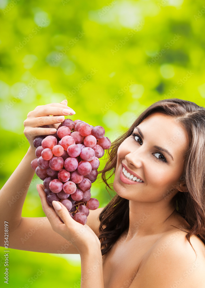 Young happy smiling woman with grapes, outdoors Young happy smiling woman with grapes, outdoors