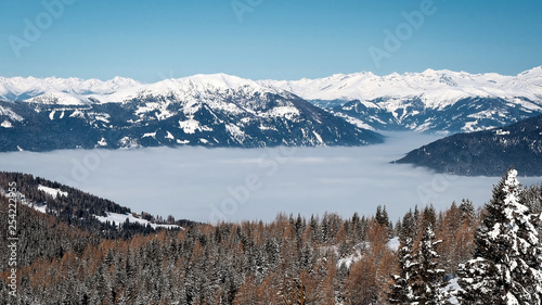Panorama of Snow Mountain Range Landscape with Blue Sky from ski resort Gerlitzen, Austria.