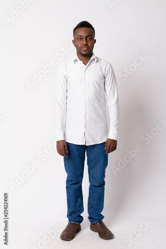 Full body shot of young African businessman standing